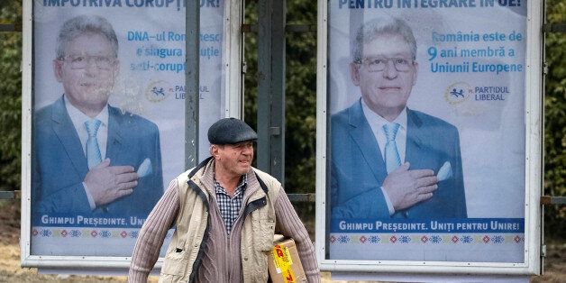 A man walks near a pre-election poster for the Chairman of Liberal Party of Moldova Mihai Ghimpu in Chisinau, Moldova, October 28, 2016. REUTERS/Gleb Garanich