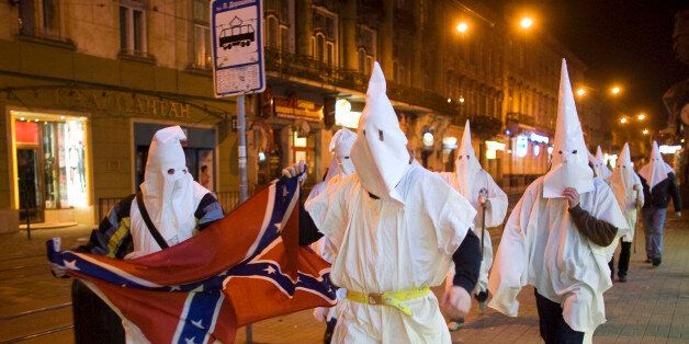 Supporters dressed as members of the Ku Klux Klan, using the occasion of Halloween to mask their faces from the police, express anti-Semitic views in Lviv October 31, 2009, REUTERS/Vasily Fedosenko (UKRAINE CONFLICT)