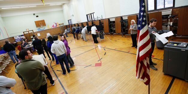 People voting at Congress Elementary School in the presidential election November 8, 2016 in Grand Rapids, Michigan. / AFP / JEFF KOWALSKY (Photo credit should read JEFF KOWALSKY/AFP/Getty Images)