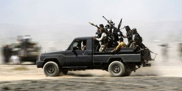 TOPSHOT - Armed Yemeni tribesmen loyal to the Shiite Huthi rebels sit in the back of an armed vehicle during a gathering to mobilise more fighters into several battlefronts on November 1, 2016 on the outskirts of the capital Sanaa. The war in Yemen escalated in March 2015 when the Saudi-led coalition launched a military campaign to push back the Huthi rebels, after they seized the capital in 2014 and then advanced on other parts of Yemen. / AFP / MOHAMMED HUWAIS (Photo credit should read MOHAMMED HUWAIS/AFP/Getty Images)