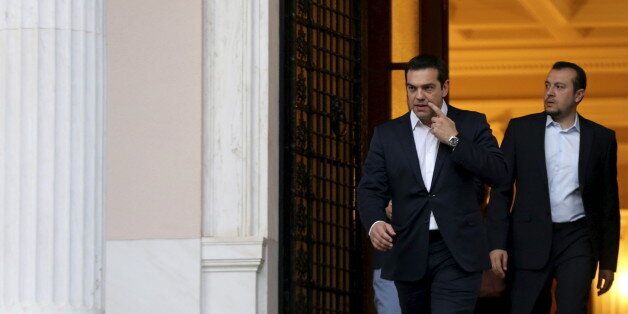 Greek Prime Minister Alexis Tsipras is followed by Minister of State Nikos Pappas (R) and government spokesman Gabriel Sakelaridis (not pictured) as he leaves his office to visit Greek President Prokopis Pavlopoulos in Athens July 8, 2015. Tsipras met Pavlopoulos to brief him on the latest developments. Euro zone members have given Greece until the end of the week to come up with a proposal for sweeping reforms in return for loans that will keep the country from crashing out of Europe's currency bloc and into economic ruin. REUTERS/Alkis Konstantinidis