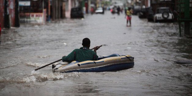 A man sails in a inflatable kayak in a flooded street during rain after Hurricane Matthew in Les Cayes, Haiti, October 21, 2016. REUTERS/Andres Martinez Casares