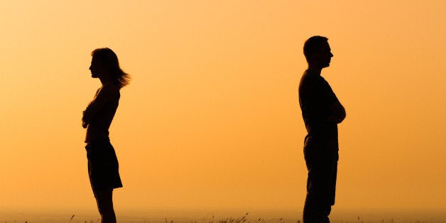 Silhouette of a angry woman and man on each other.