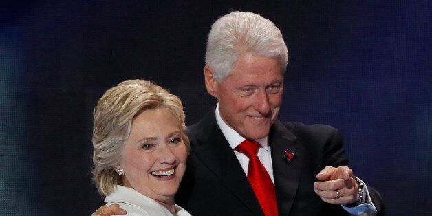 Democratic presidential nominee Hillary Clinton stands with her husband, former president Bill Clinton, after accepting the nomination on the final night of the Democratic National Convention in Philadelphia, Pennsylvania, U.S. July 28, 2016. REUTERS/Mike Segar