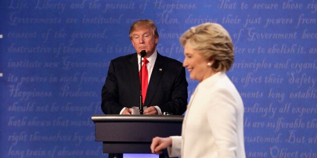 Republican presidential nominee Donald Trump waits behind his podium as Democratic presidential nominee Hillary Clinton makes her way off the stage following the third presidential debate at UNLV in Las Vegas, Wednesday, Oct. 19, 2016. (AP Photo/David Goldman)