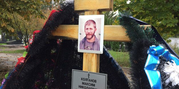 A portrait of Russian contractor Maxim Kolganov, who was killed in combat in Syria, is pictured on a grave in his hometown of Togliatti, Russia, September 29, 2016. Picture taken September 29, 2016. To match Insight MIDEAST-CRISIS/SYRIA-RUSSIA REUTERS/Maria Tsvetkova