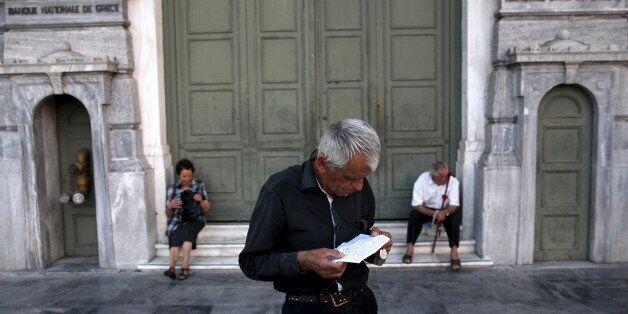 A pensioner waits to receive part of his pension at a National Bank branch in Athens, Greece July 13, 2015. Euro zone leaders clinched a deal with Greece on Monday to negotiate a third bailout to keep the near-bankrupt country in the euro zone after a whole night of haggling at an emergency summit. REUTERS/Yiannis Kourtoglou TPX IMAGES OF THE DAY