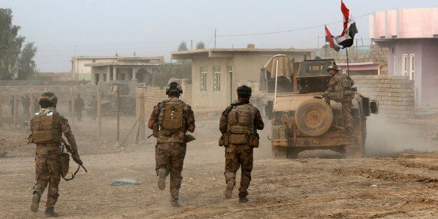 Iraq's elite counterterrorism forces advance toward Islamic State positions in the village of Tob Zawa, about 9 kilometers (5Â½ miles) from Mosul, Iraq, Tuesday, Oct. 25, 2016. Iraqi forces battled Islamic State fighters for a third day in a remote western town far from Mosul on Tuesday, but the U.S.-led coalition insisted the latest in a series of