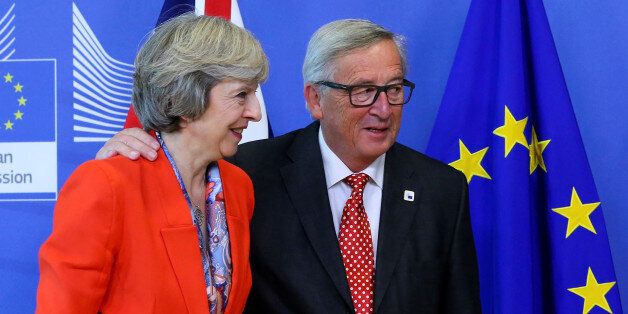 British Prime Minister Theresa May (L) is welcomed by European Commission President Jean-Claude Juncker at the EC headquarters in Brussels, Belgium October 21, 2016. To match Insight BRITAIN-EU/MESSAGES REUTERS/Yves Herman/File Photo