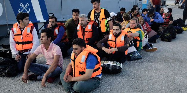 Migrants from Syria wait at the port of Kos island, Greece, on Tuesday, June 2, 2015, after they were rescued by Greek Coast Guard while they were trying to cross from Turkey to Greece on a dinghy. Greece and Italy are the main points of entry into the European Union for refugees and economic migrants from the Middle East and Africa hoping to reach other European Union countries. (AP Photo/Petros Giannakouris)