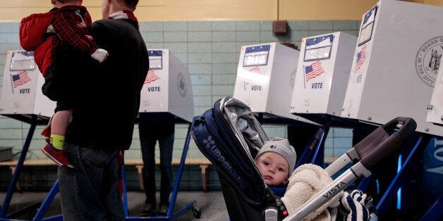NEW YORK, NY - NOVEMBER 8: A baby waits as people vote at a polling site at Public School 261, November 8, 2016 in New York City. Citizens of the United States will choose between Republican presidential candidate Donald Trump and Democratic presidential candidate Hillary Clinton. (Photo by Drew Angerer/Getty Images)