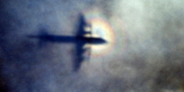 FILE - In this March 31, 2014 file photo, the shadow of a Royal New Zealand Air Force P3 Orion is seen on low level cloud while the aircraft searches for missing Malaysia Airlines Flight MH370 in the southern Indian Ocean, near the coast of Western Australia. Australian authorities said Thursday, Dec. 3, 2015 new analysis confirms they've likely been searching in the right place for a missing Malaysian airliner. (AP Photo/Rob Griffith, File)