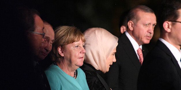 German Chancellor Angela Merkel (3rd L), Russia's President Vladimir Putin (2nd L), and Turkey's President Recep Tayyip Erdogan (R) are seen as G20 leaders and their spouses walk for a group picture prior to a dinner banquet at the G20 Summit in Hangzhou on September 4, 2016.World leaders are gathering in Hangzhou for the 11th G20 Leaders Summit from September 4 to 5. / AFP / JOHANNES EISELE (Photo credit should read JOHANNES EISELE/AFP/Getty Images)