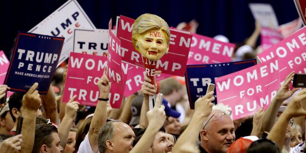 A supporter holds up a mask representing Democratic presidential candidate Hillary Clinton before a rally with Republican presidential candidate Donald Trump, Saturday, Oct. 29, 2016, in Phoenix. (AP Photo/John Locher)