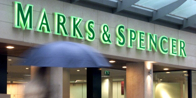 A pedestrian walks past a Marks & Spencer shop in Brussels March 29, 2001. Britain's Marks & Spencer clothing chain, struggling abroad and battling retail competition at home, said on Thursday it would shed much of its non-UK business and cut over 4,000 jobs in a radical shake-up to rebuild profits and sales.THR/WS