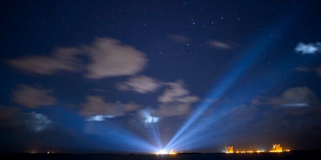 CAPE CANAVERAL, FL - SEPTEMBER 7: In this handout photo provided by NASA, the United Launch Alliance Atlas V rocket with NASA's Origins, Spectral Interpretation, Resource Identification, Security-Regolith Explorer (OSIRIS-REx) spacecraft on board is seen illuminated in the distance in this thirty second exposure on September 7, 2016 at Cape Canaveral Air Force Station in Florida. OSIRIS-REx is scheduled to launch on Sept. 8 and will be the first U.S. mission to sample an asteroid, retrieve at least two ounces of surface material and return it to Earth for study. The asteroid, Bennu, may hold clues to the origin of the solar system and the source of water and organic molecules found on Earth. (Photo by Joel Kowsky/NASA via Getty Images)