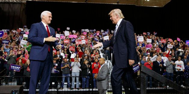 Republican presidential nominee Donald Trump, right, shakes hands with vice presidential candidate Gov. Mike Pence, R-Ind., during a campaign rally, Saturday, Oct. 22, 2016, in Cleveland. (AP Photo/ Evan Vucci)