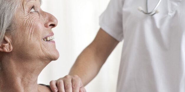 Woman being comforted by healthcare professional, cropped