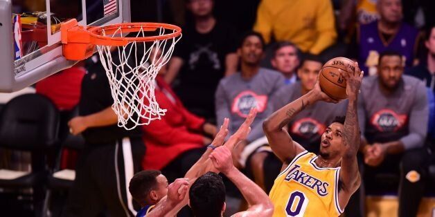Nick Young (R) of the Los Angeles Lakers tries to shoot the ball during a match against the Golden State Warriors in their NBA game in Los Angeles, California on November 4,2016. / AFP / Frederic J. BROWN (Photo credit should read FREDERIC J. BROWN/AFP/Getty Images)