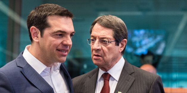 Greek Prime Minister Alexis Tsipras, left, speaks with Cypriot President Nicos Anastasiades during a round table meeting at the EU-CELAC summit in Brussels on Thursday, June 11, 2015. (AP Photo/Geert Vanden Wijngaert)