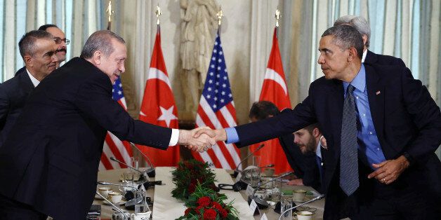 U.S. President Barack Obama, right, shakes hands with Turkish President Recep Tayyip Erdogan after a bilateral meeting, in Paris, France, Tuesday, Dec. 1, 2015. The leaders discussed the continuing crisis in Syria, and the fight against the Islamic State group. (AP Photo/Yasin Bulbul, Presidential Press Service, Pool)