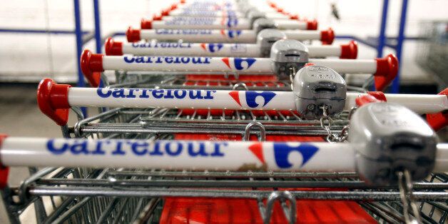 Supermarket buggies are seen locked together during a strike action at a Carrefour supermarket in Brussels, Wednesday Feb. 24, 2010. Workers at Carrefour Belgium SA, the Belgian arm of the French retailer, went on strike Wednesday after the company said it would close 21 of its stores, lay off at least 1,700 workers and sell 30 of its outlets to slash costs and reverse a steadily dropping market share. (AP Photo/Virginia Mayo)