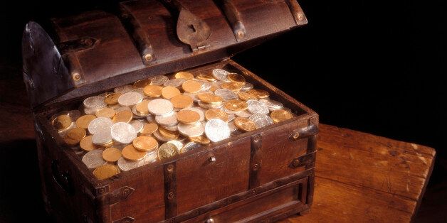 Wooden chest full of silver and gold coins.