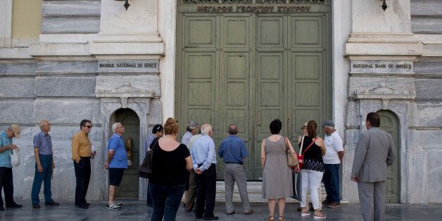 Athens residents wait for a branch of the National Bank of Greece to open in central Athens on Tuesday, June 28, 2016. Greece introduced capital controls for bank transactions a year ago amid financial turmoil triggered by bailout negotiation delays. Country residents can still withdraw a maximum of 420 euros (around $465) a week. (AP Photo/Petros Giannakouris)