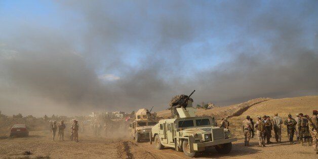 MOSUL, IRAQ - OCTOBER 20: Soldiers of Iraqi Army and Hashd al-Shaabi militias arrive at Saleh Village after retaking of Khalid, Saleh and Zanawer Villages of Qayyarah Town from Daesh terrorists during the operation to retake Iraq's Mosul from Daesh terrorists, in Mosul, Iraq on October 20, 2016. A much anticipated Mosul offensive to liberate the city from Daesh began midnight of 16th of October. (Photo by Hemn Baban/Anadolu Agency/Getty Images)