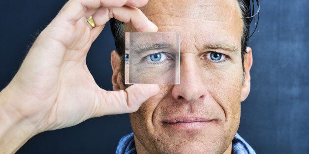 Vision: man looking through lens