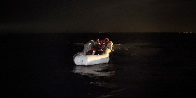 Refugees and migrants wait to be rescued from their sinking rubber boat some eight nautical miles off Libya's Mediterranean coastline on October 12, 2016.A growing number of people are attempting the treacherous sea journey from Libya or Egypt, after the closure of the Balkan migrant trail route leading from Greece to western Europe. / AFP / ARIS MESSINIS (Photo credit should read ARIS MESSINIS/AFP/Getty Images)