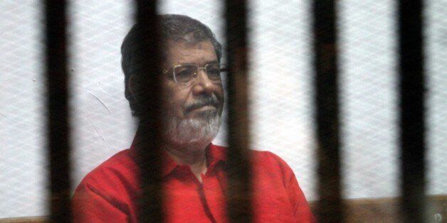 CAIRO, EGYPT - JUNE 18: Egypts ousted President Mohamed Morsi is seen behind the bars during his trial on charges of espionage on behalf of Qatar at the Police Academy in Cairo, Egypt on June 18, 2016. (Photo by Ahmed Gamil/Anadolu Agency/Getty Images)