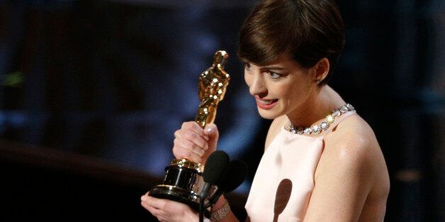 Anne Hathaway accepts the award for best supporting actress for her role in