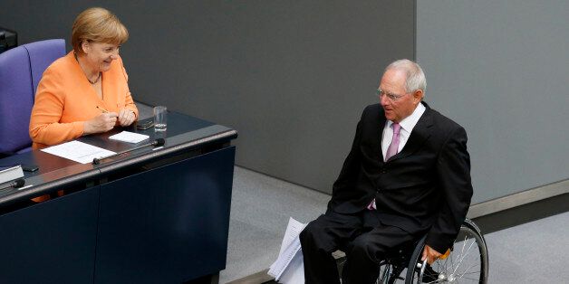 German Finance Minister Wolfgang Schaueble (R) passes Chancellor Angela Merkel after addressing the Bundestag, the lower house of parliament in Berlin September 11, 2012. Schaeuble said on Tuesday that the only way to solve the euro zone crisis was for the bloc's member states to correct the policy mistakes of the past. REUTERS/Fabrizio Bensch (GERMANY - Tags: POLITICS BUSINESS)