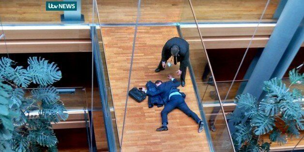ADDS THAT NO CROPPING IS PERMITTED AND THAT PHOTO MUST BE USED IN IT'S ENTIRETY. ITV NEWS LOGO MUST BE RETAINED. ALSO REITERATES MANDATORY CREDIT - British UK Independence Party Member of the European Parliament Steven Woolfe lies on the ground after losing consciousness in the European Parliament building in Strasbourg France Thursday Oct. 6, 2015. Britain's fractious, right-wing U.K. Independence Party erupted into violence Thursday that left Steven Woolfe hospitalized with a head injury after an
