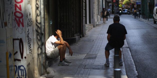 ATHENS, GREECE - JULY 13: Men sit in the street in downtown Athens on July 13, 2015 in Athens, Greece. Eurozone leaders have reportedly made an 'agreement' on the Greek debt crisis in Brussels. After lengthy talks EU President Donald Tusk tweeted that a bailout programme was 'all ready to go'. (Photo by Christopher Furlong/Getty Images)