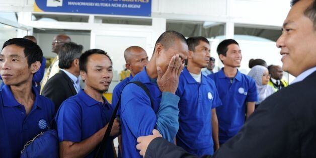 Hostage of Somali pirates react as they arrive at the Jomo Kenyatta International Airport in Nairobi on October 23, 2016 after being freed with other hostages.Somali pirates have freed 26 Asian hostages held for nearly five years after the hijacking of their fishing vessel, the last commercial ship seized at the height of the country's piracy scourge, negotiators said on October 22, 2016. The crew of the Naham 3, the second longest held hostage by Somali pirates, were taken captive when their Omani-flagged vessel was seized in March 2012 south of the Seychelles. / AFP / STRINGER (Photo credit should read STRINGER/AFP/Getty Images)
