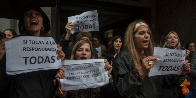 Women stop work and other activities for an hour to join a 'women's strike' organized after the brutal killing of a 16-year-old girl, in Buenos Aires, on October 19, 2016.The brutal killing of a teenager who was allegedly raped and impaled on a spike by drug dealers has sparked outrage in Argentina. Lucia Perez, a high school student in the resort city of Mar del Plata, died on October 8 after being brought to the hospital by two men who said she had overdosed on drugs. But after doctors noticed signs of violent sexual penetration, investigators pieced together a different story. / AFP / Eitan ABRAMOVICH (Photo credit should read EITAN ABRAMOVICH/AFP/Getty Images)