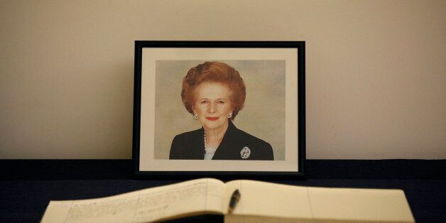 A condolence book is placed in front of a picture of former British Prime Minister Margaret Thatcher at the British Consulate in Hong Kong Tuesday, April. 9, 2013. Her spokesman said Thatcher died Monday morning of a stroke. (AP Photo/Vincent Yu)