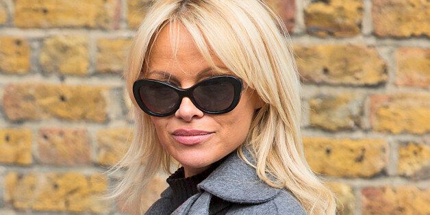FILE - In this Wednesday, Oct. 12, 2016 file photo, Pamela Anderson poses for photographers, during a photo call, in London. Former