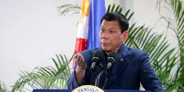 Philippine President Rodrigo Duterte gestures as he speaks at the Davao International Airport after arrving back from a state visit to Brunei and China on October 22, 2016.Philippine President Rodrigo Duterte said on October 22 he would not sever his nation's alliance with the United States, as he clarified his announcement that he planned to 'separate'. / AFP / MANMAN DEJETO (Photo credit should read MANMAN DEJETO/AFP/Getty Images)