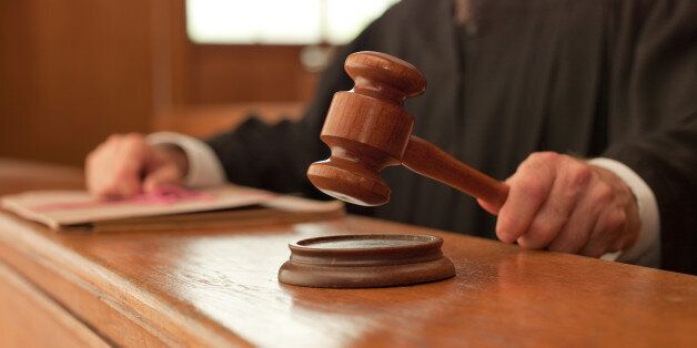 Judge holding gavel in courtroom