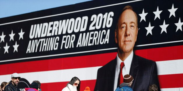People stand in line waiting to enter the Underwood 2016 booth near the Peace Center where the CBS News Republican presidential debate will occur, Saturday, Feb. 13, 2016, in Greenville, S.C. Frank Underwood is a fictional character and the protagonist of the Netflix show House of Cards. He is portrayed by Kevin Spacey. (AP Photo/John Bazemore)