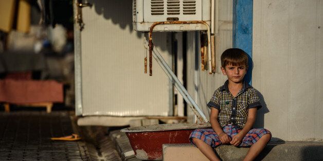 A Syrian child sits at a refugee camp in the Kilis district of Gaziantep, southeastern Turkey, on October 23, 2016.France's foreign minister urged the international community to 'do everything' to end the 'massacre' in the Syrian city of Aleppo after fighting resumed following a 72-hour truce declared by Damascus ally Russia. / AFP / OZAN KOSE (Photo credit should read OZAN KOSE/AFP/Getty Images)