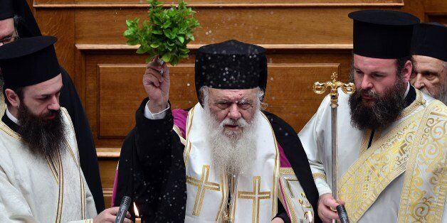 Archbishop of Athens and All Greece, Ieronimos II (C) blesses the members of parliament during a swearing-in ceremony of the new deputies that were elected in the September 20 general elections, at the Greek parliament in Athens on October 3, 2015. AFP PHOTO/ POOL / LOUISA GOULIAMAKI (Photo credit should read LOUISA GOULIAMAKI/AFP/Getty Images)