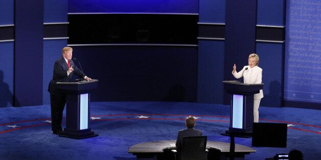 Donald Trump, 2016 Republican presidential nominee, and Hillary Clinton, 2016 Democratic presidential nominee, speak during the third U.S. presidential debate in Las Vegas, Nevada, U.S., on Wednesday, Oct. 19, 2016. Donald Trump is trying another wild-card play in the third and final presidential debate with Hillary Clinton in perhaps his last chance to reverse his campaign's spiral and halt his Democratic rival's rising electoral strength. Photographer: Andrew Harrer/Bloomberg via Getty Images