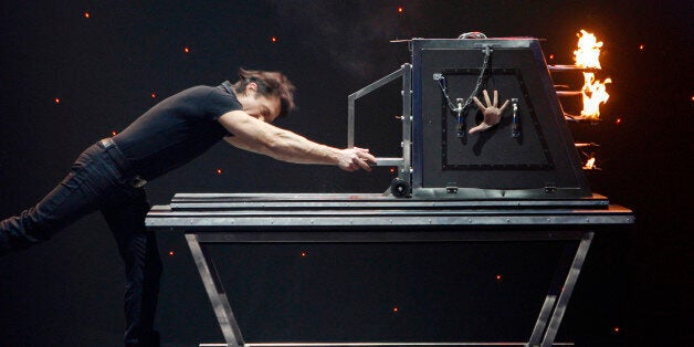 Illusionist Gaetano Riggiano performs his trick at Rome's Olympic theatre, Monday Jan. 26, 2009. Italy's sixth festival of magic, otherwise known as Supermagic 2009, opened Friday at the Teatro Olimpico in Rome. It is set to run until Feb. 1, 2009. (AP Photo/Alessandra Tarantino)