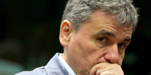 Greece's Finance Minister Eucleidis Tsakalotos waits for the start of a meeting of EU finance ministers in Brussels on Wednesday, May 25, 2016. Eurozone finance ministers struck a deal early Wednesday clearing the way for Greece to access a fresh round of bailout funds, while also laying out debt relief measures aimed at securing the involvement of the International Monetary Fund, or IMF. (AP Photo/Virginia Mayo)