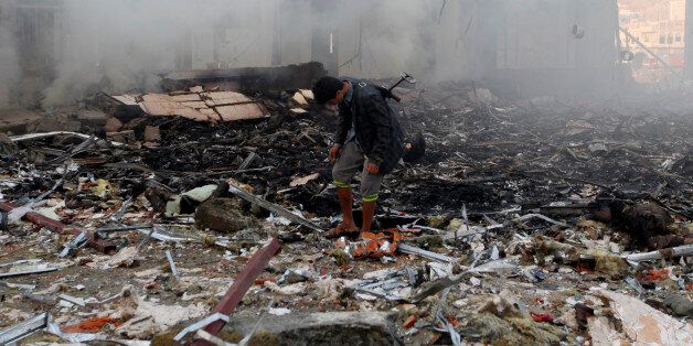 A Yemeni inspects the rubble of a destroyed building following reported airstrikes by Saudi-led coalition air-planes on the capital Sanaa on October 8, 2016.Rebels in control of Yemen's capital accused the Saudi-led coalition fighting them of killing or wounding dozens of people in air strikes on Sanaa. The insurgent-controlled news site sabanews.net said that coalition planes hit a building in the capital where people had gathered to mourn the death of an official, resulting in 'dozens of dead