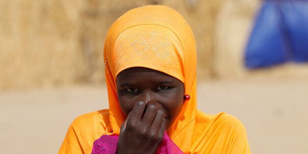 A Nigerien displaced girl reacts at a camp of the city of Diffa, Niger June 18, 2016. REUTERS/Luc